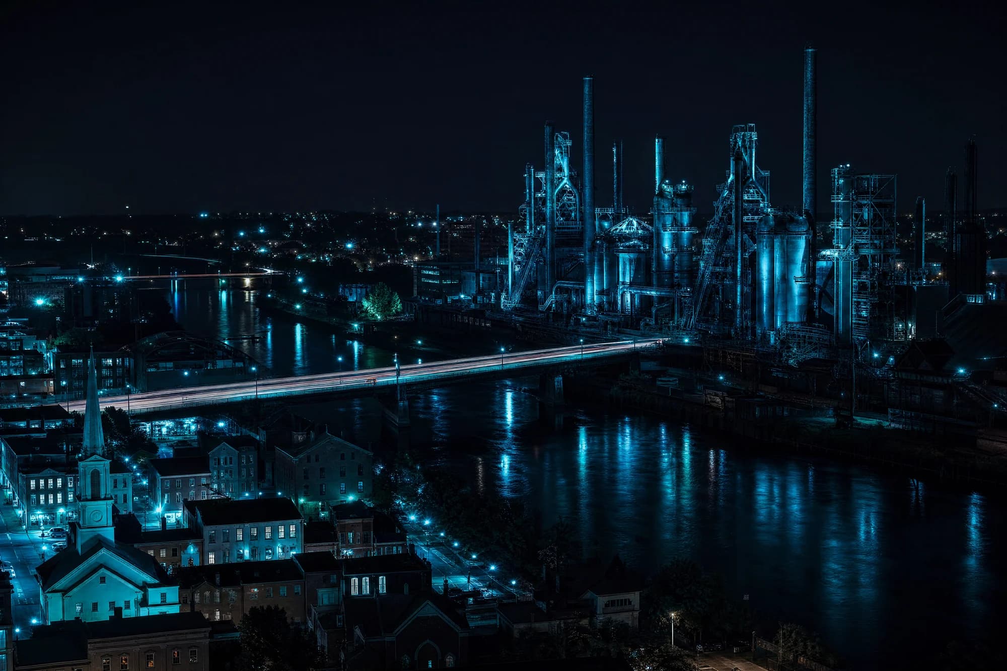 Stylized night render of Bethlehem with the Steel Stacks and Main Street lit in teal